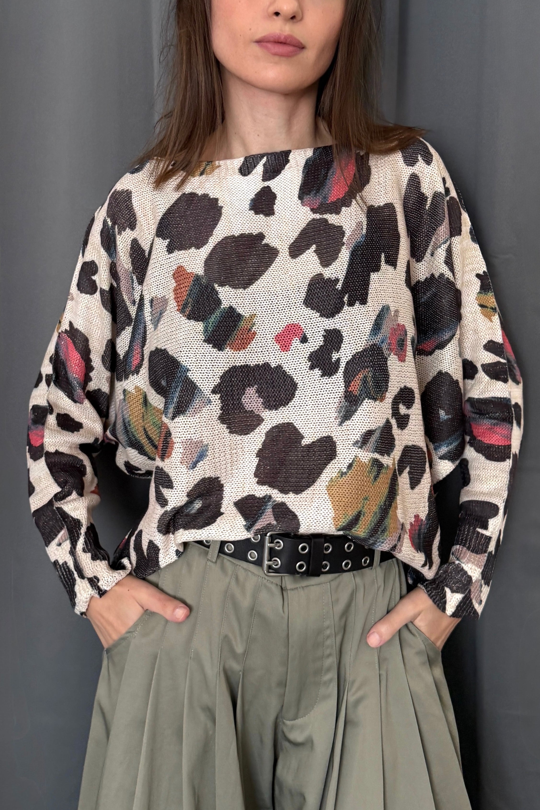 Front portrait of model wearing the Livia Made in Italy batwing printed sweater in abstract leopard multi print