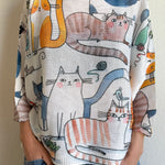 Styled front view of the Livia Made in Italy batwing printed sweater paired with jeans