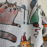 Close-up detail of the playful cats print on the Livia batwing sweater