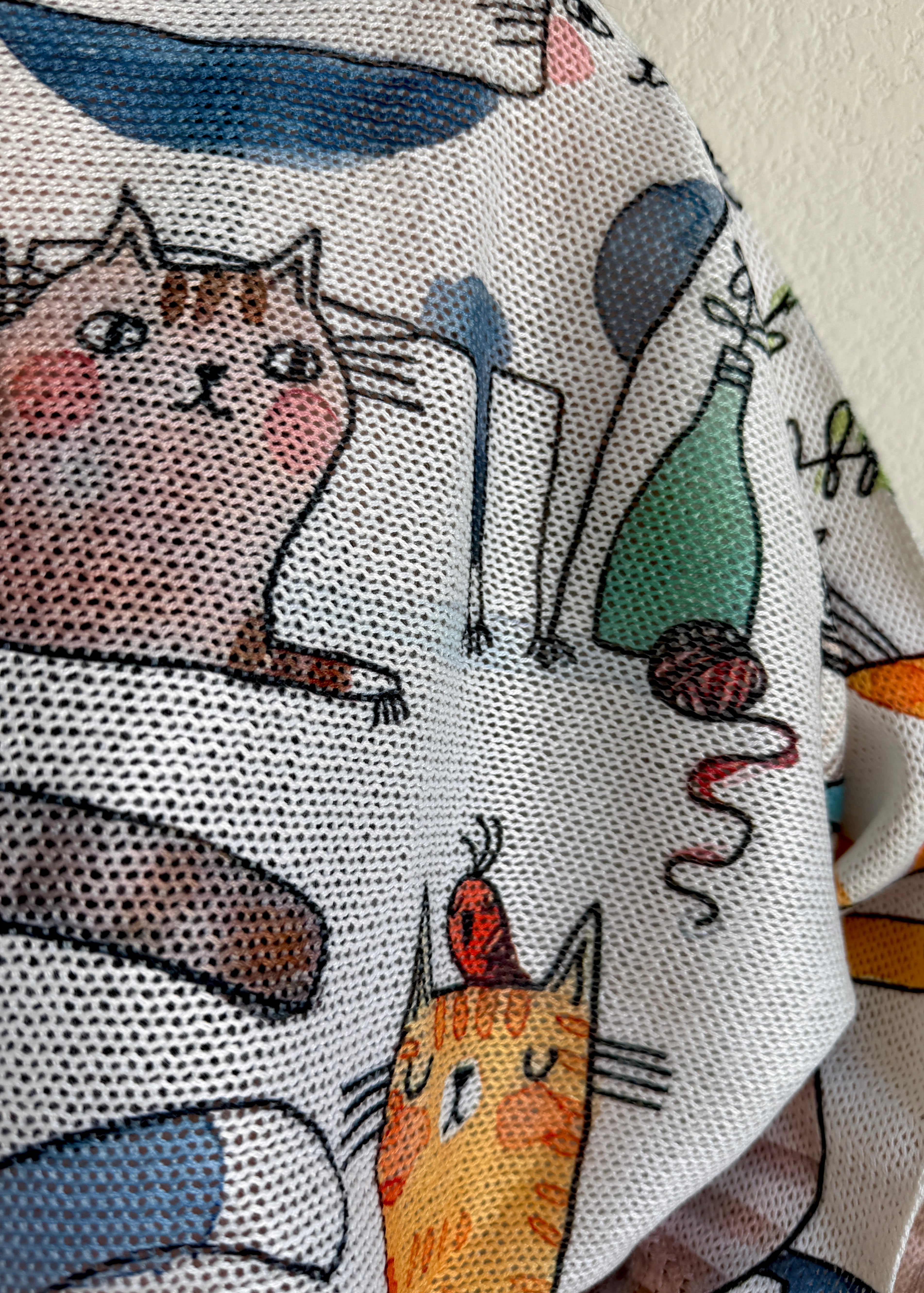 Close-up detail of the playful cats print on the Livia batwing sweater