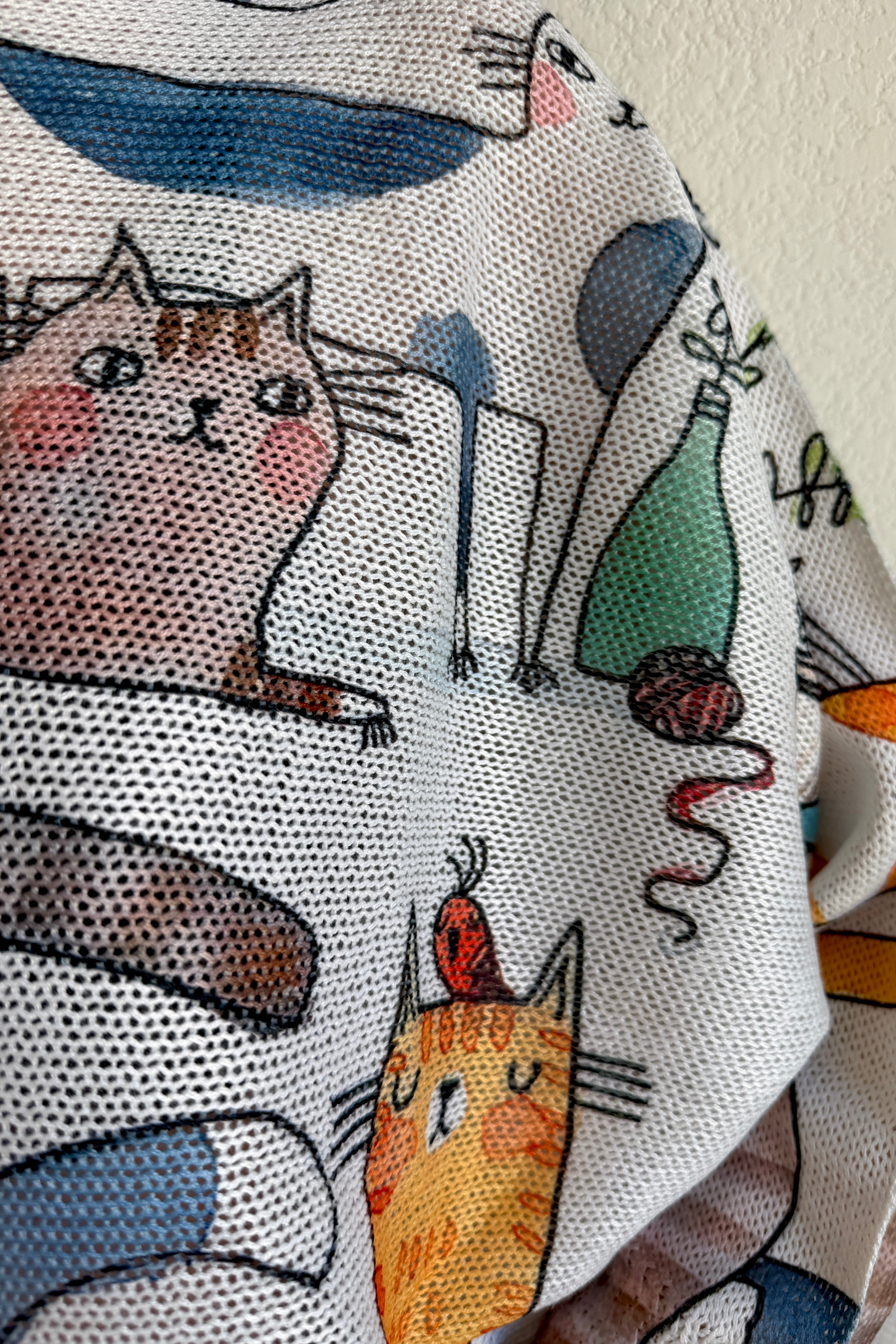 Close-up detail of the playful cats print on the Livia batwing sweater