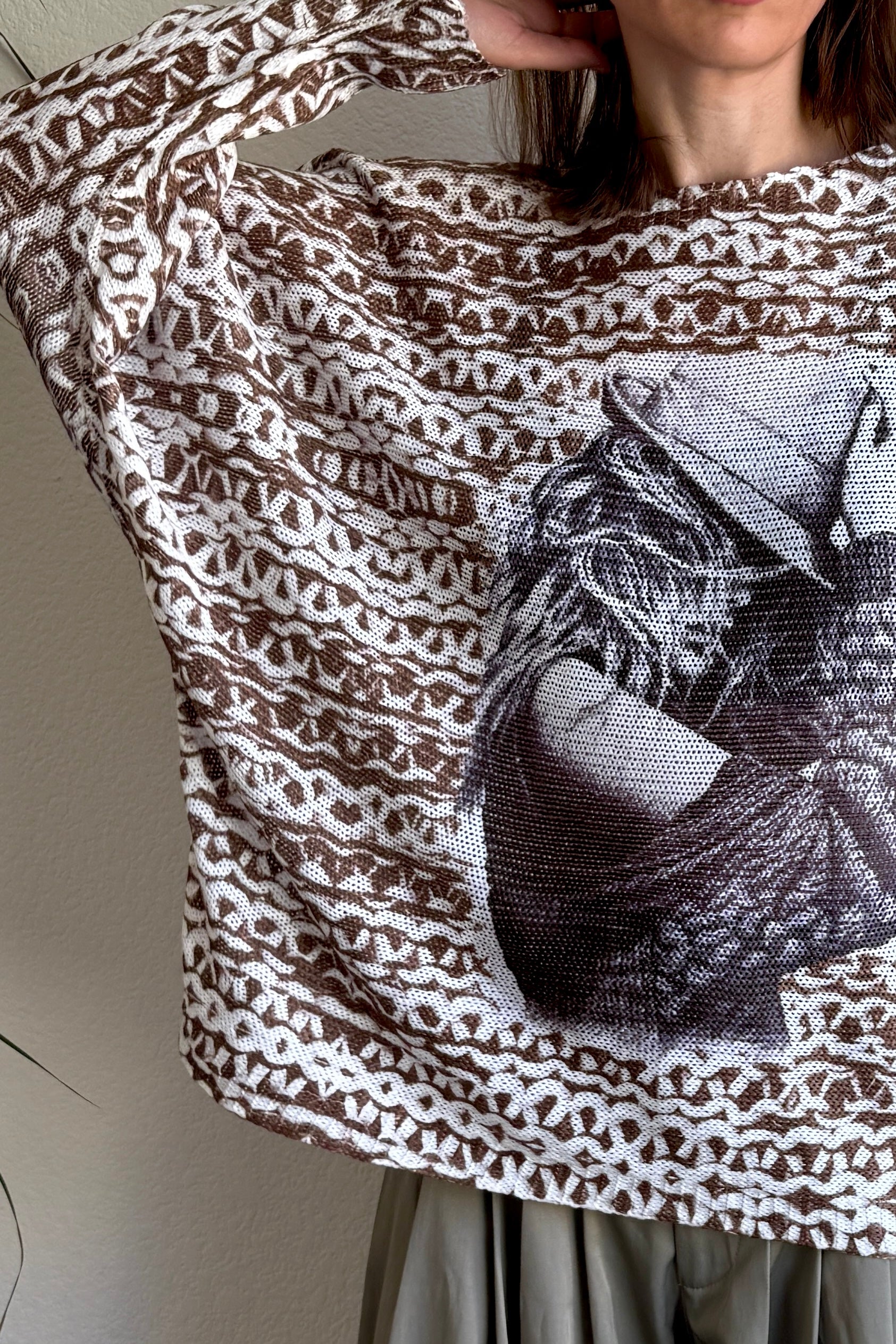 Close-up front detail of italian sweater  highlighting the cowgirl print and soft knit texture