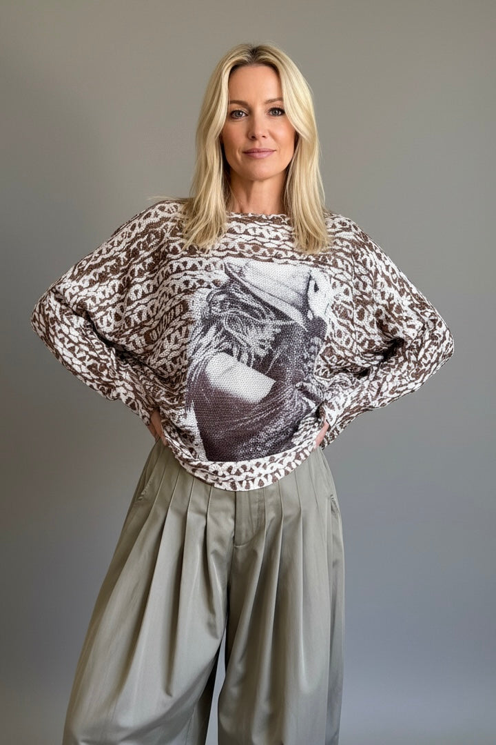Front portrait of model wearing the Livia Made in Italy batwing printed sweater with cowgirl print