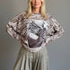 Front portrait of model wearing the Livia Made in Italy batwing printed sweater with cowgirl print