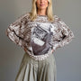 Front portrait of model wearing the Livia Made in Italy batwing printed sweater with cowgirl print