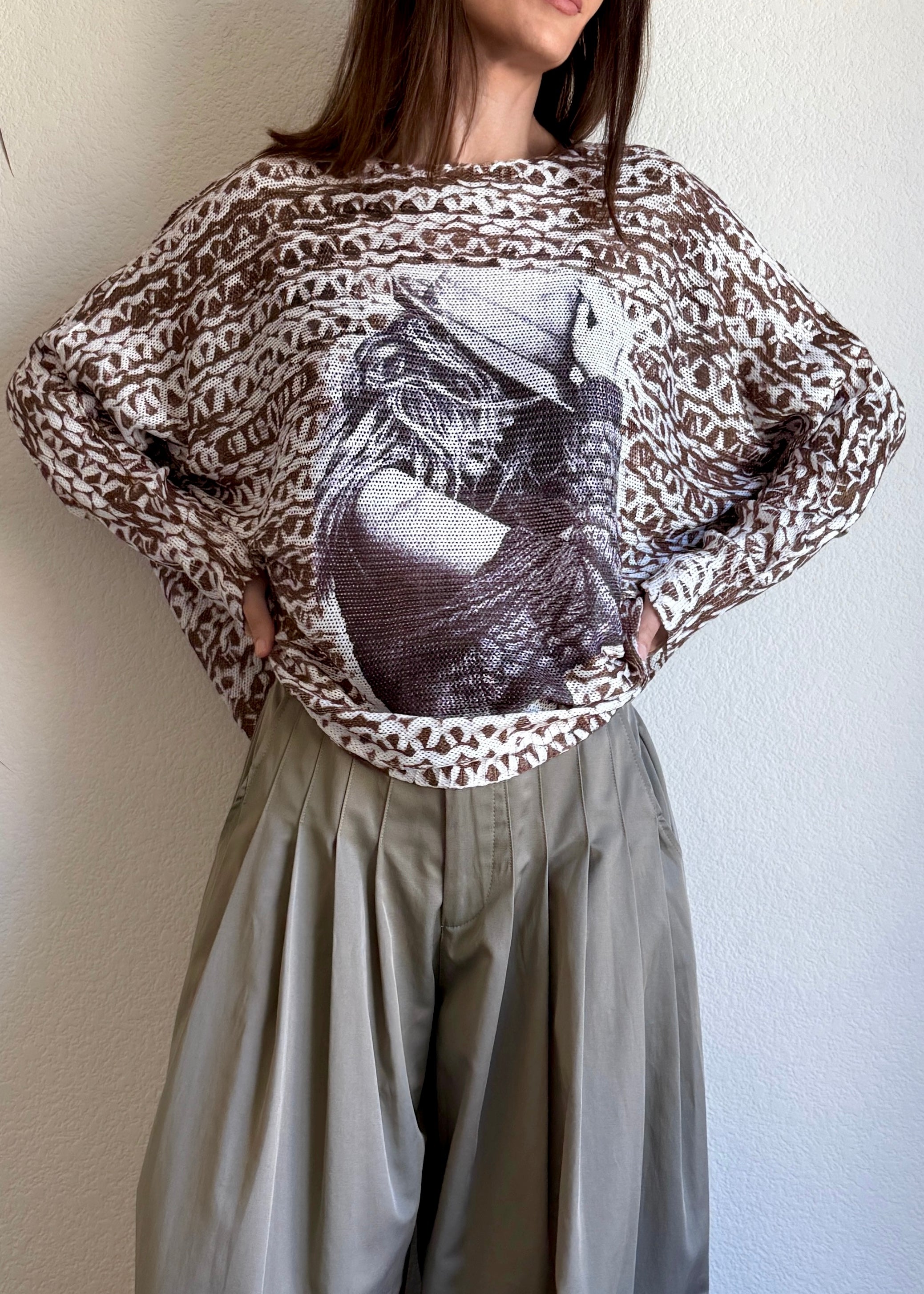 Styled front view of the Livia batwing printed sweater in a casual indoor setting