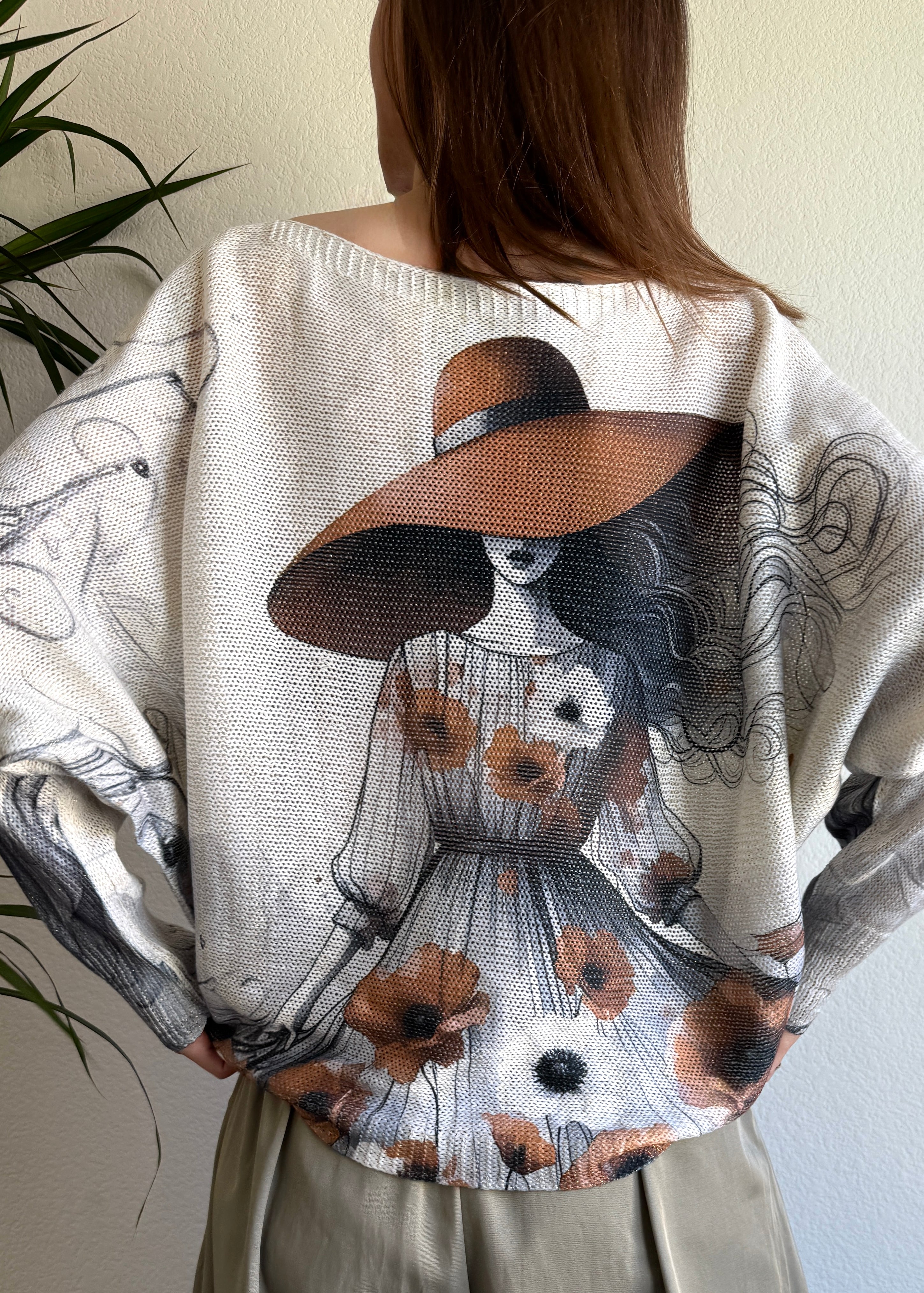 Back view of the sweater highlighting the oversized batwing fit