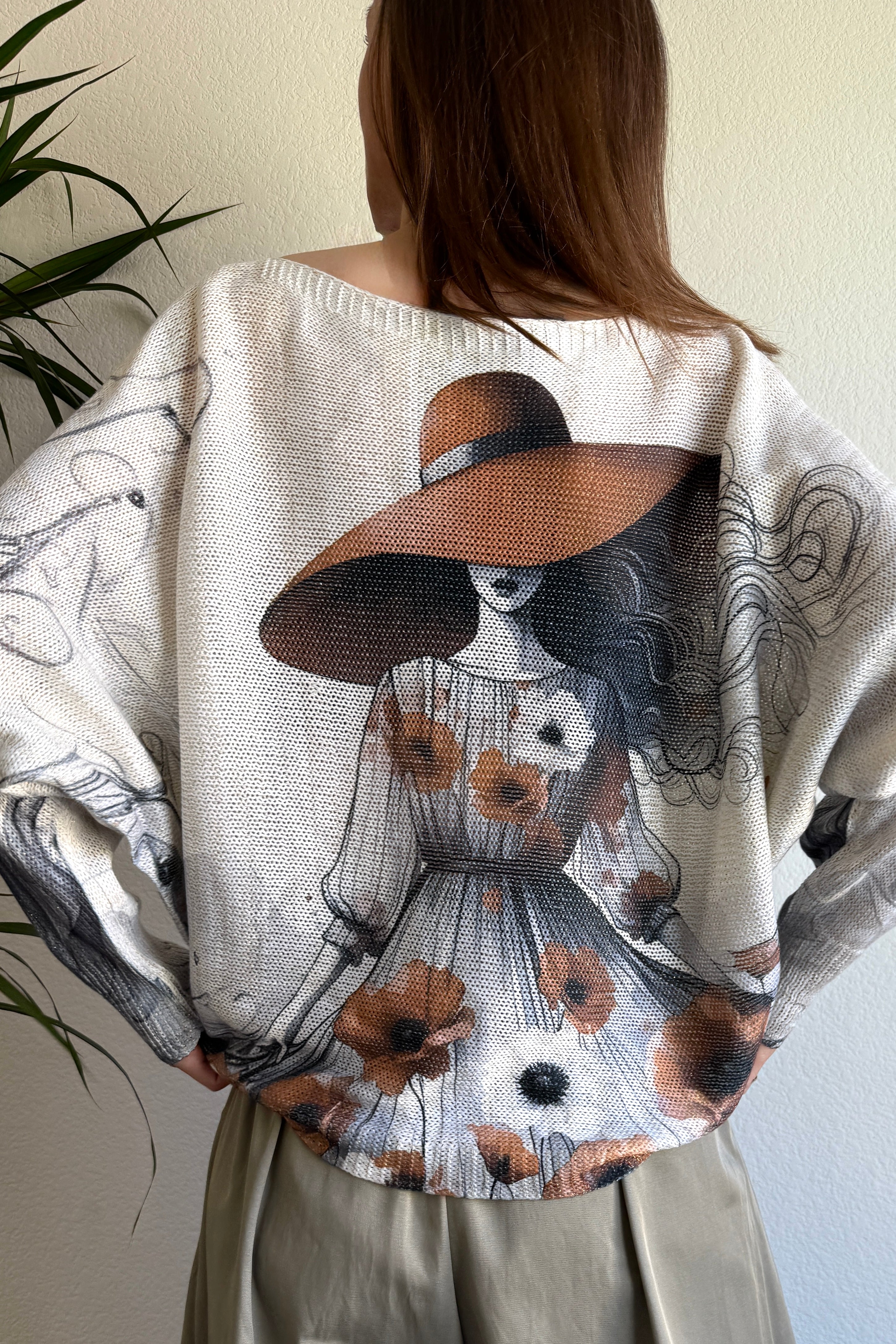 Back view of the sweater highlighting the oversized batwing fit