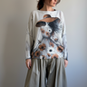 Front portrait of model wearing the Livia Made in Italy batwing printed sweater with Lady in Hat artwork