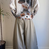 Full-body view of the Livia Made in Italy batwing sweater styled with wide-leg pants