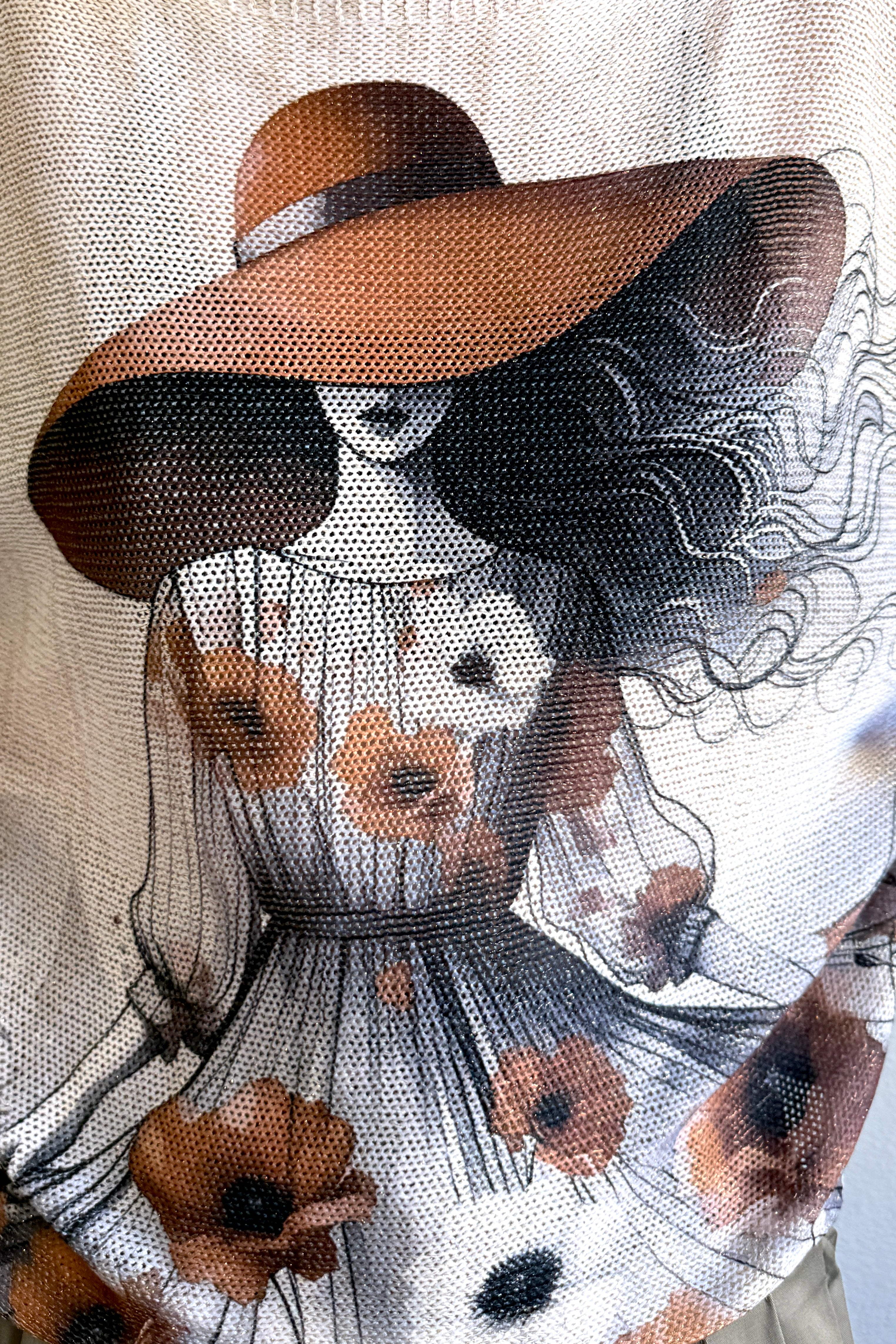 Close-up detail of the Lady in Hat print on the Livia batwing sweater