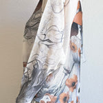 Side view of the batwing printed sweater showing drape and relaxed silhouette