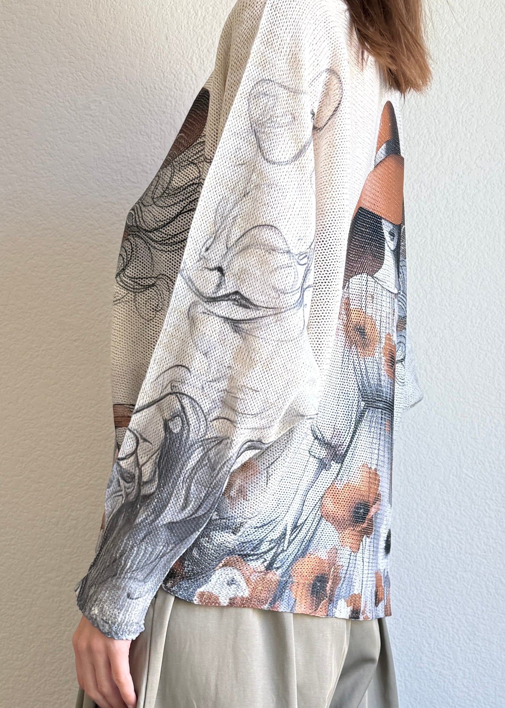 Side view of the batwing printed sweater showing drape and relaxed silhouette
