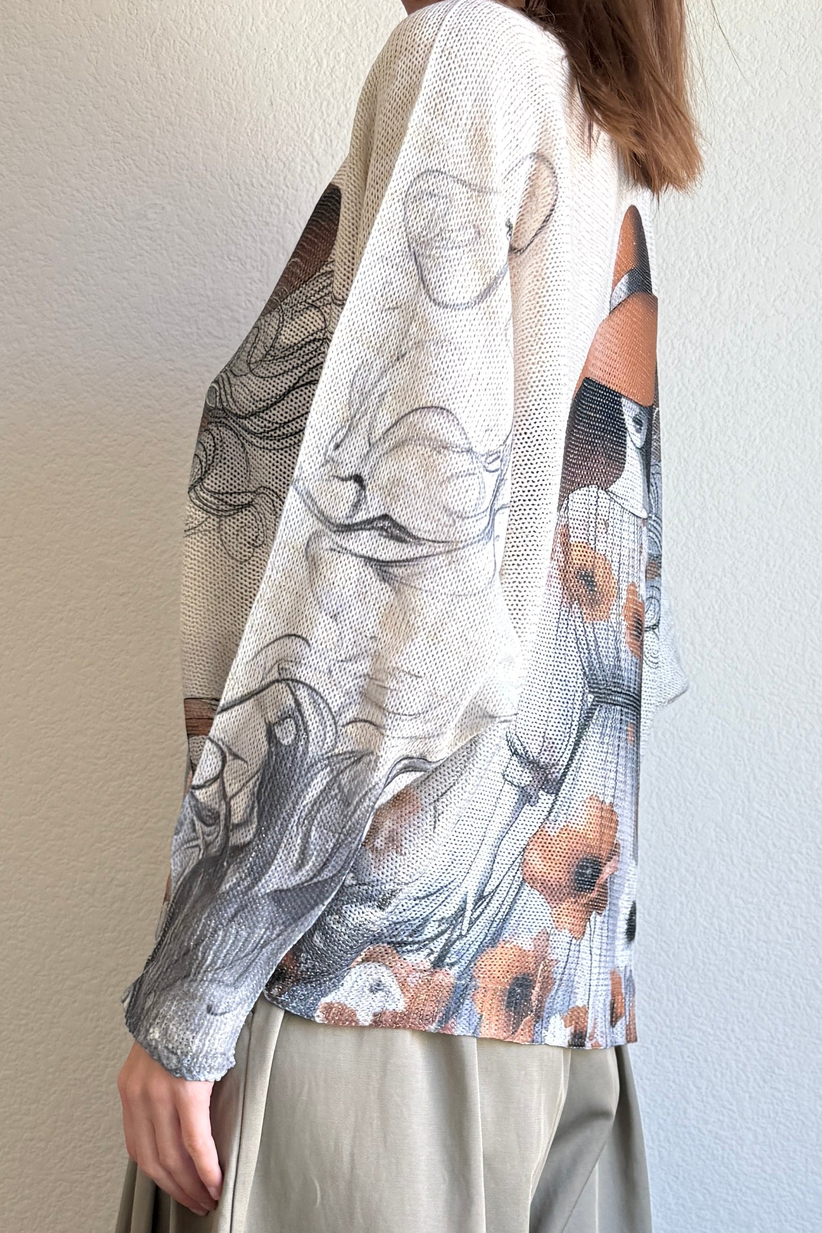 Side view of the batwing printed sweater showing drape and relaxed silhouette