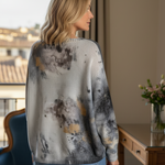 Back view of the batwing printed sweater showing relaxed fit and abstract pattern