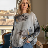 Front portrait of model wearing the Livia Made in Italy batwing printed sweater in smoke and gold abstract print