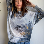 Styled front view of the Livia batwing printed sweater paired with jeans