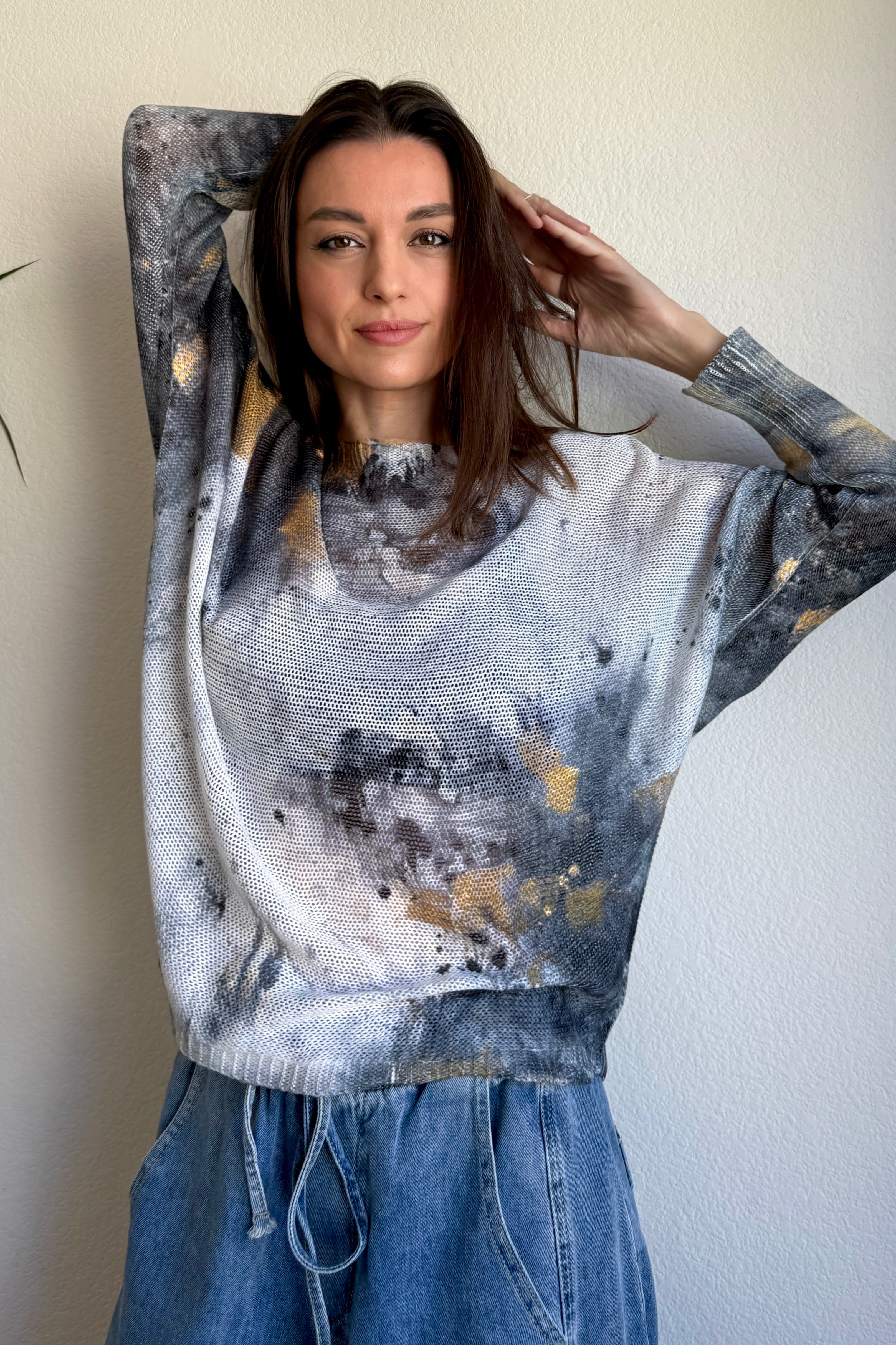 Styled front view of the Livia batwing printed sweater paired with jeans