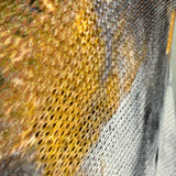 Close-up detail of the smoke and gold abstract print on the Livia batwing sweater