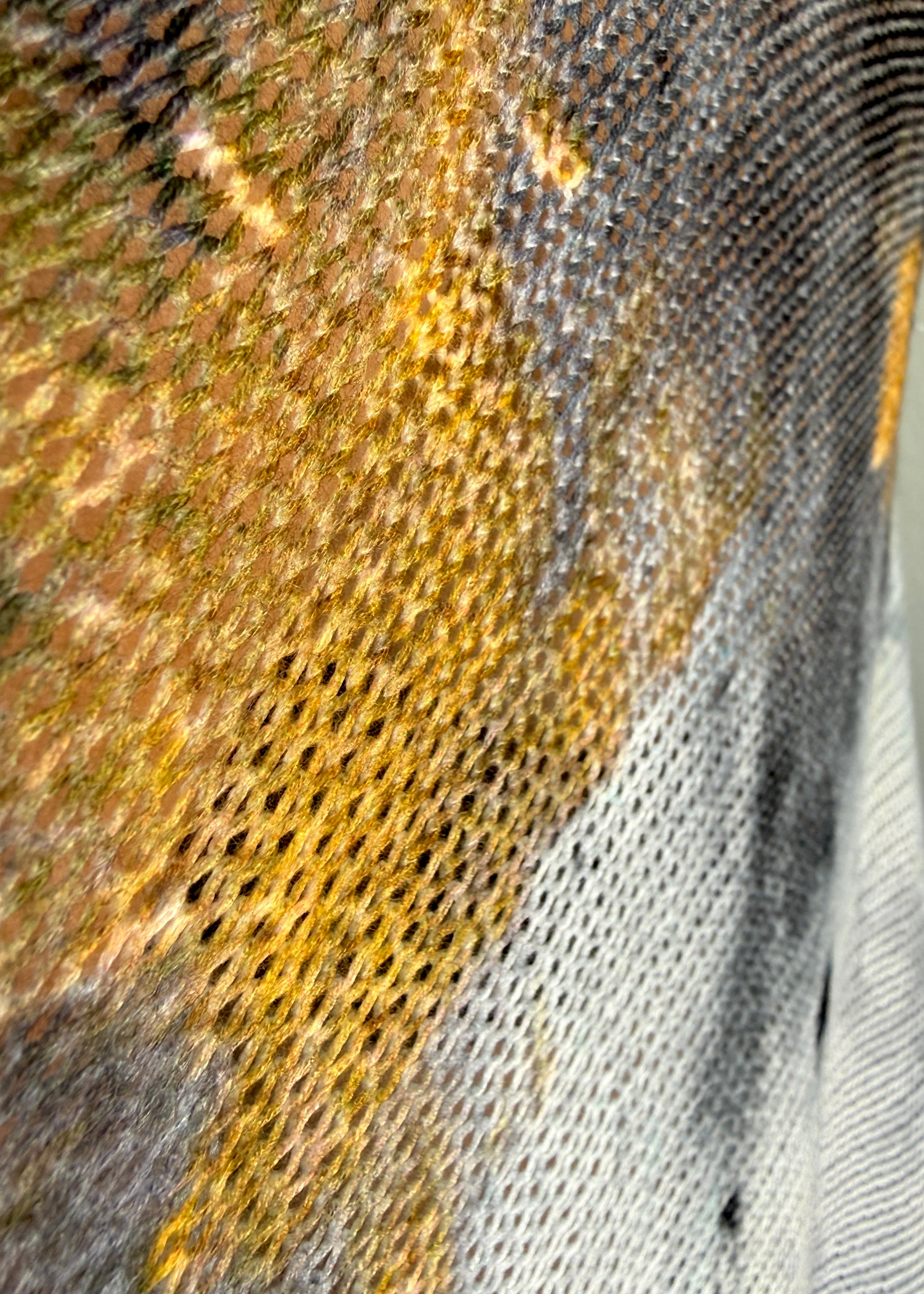 Close-up detail of the smoke and gold abstract print on the Livia batwing sweater