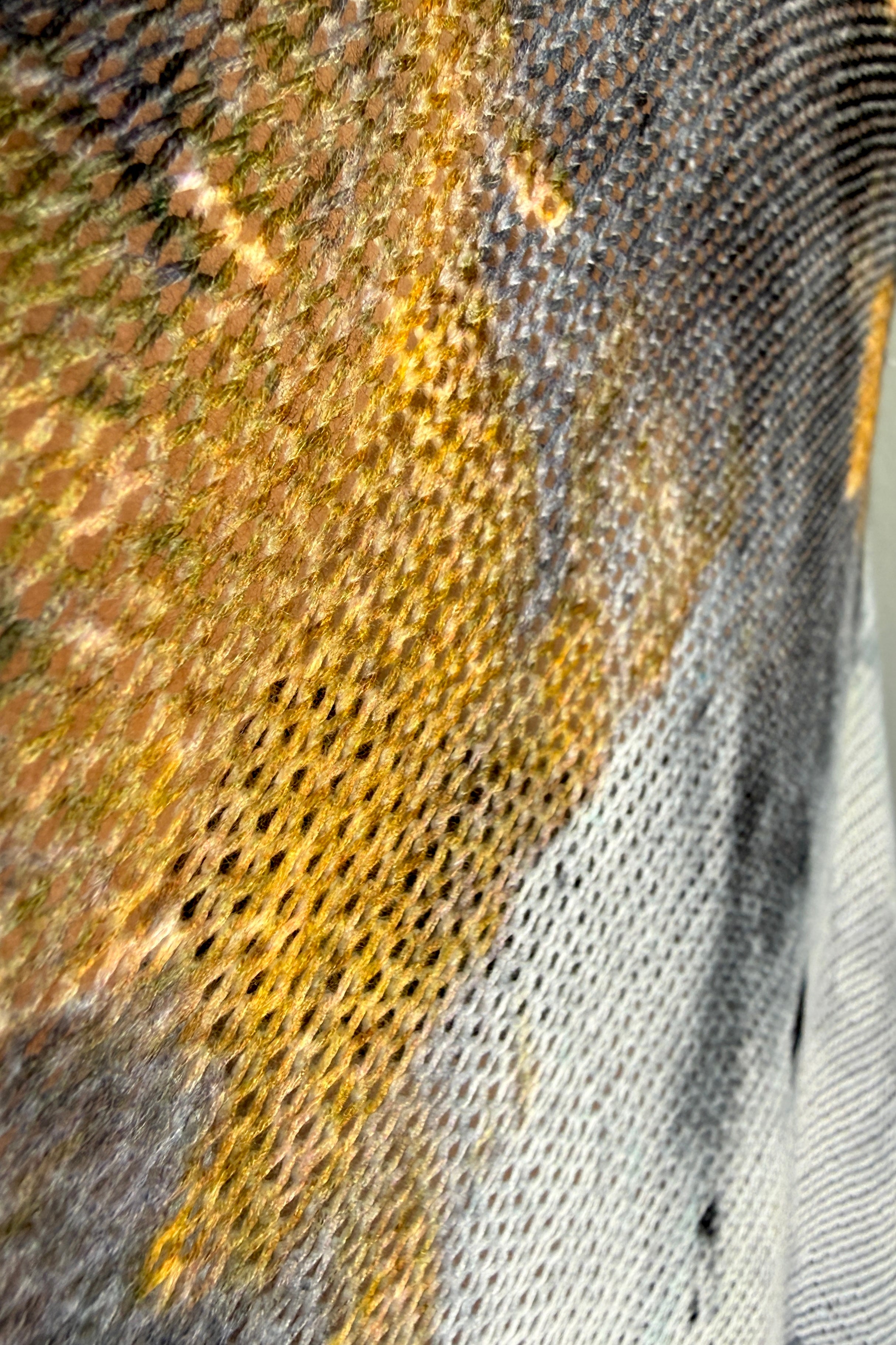 Close-up detail of the smoke and gold abstract print on the Livia batwing sweater