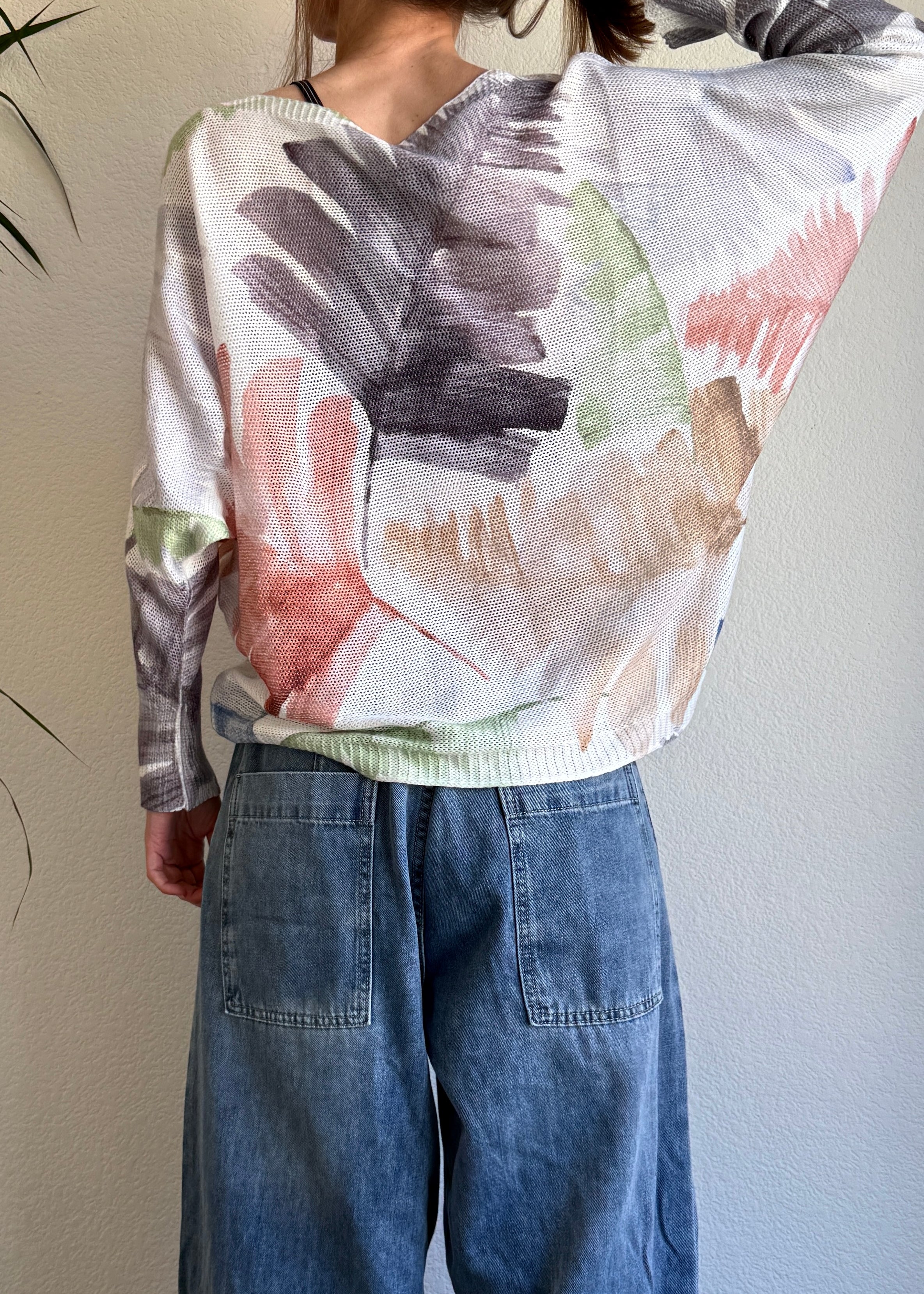 Back view of the sweater showing the all-over watercolor palm print