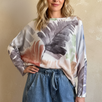Front portrait of model wearing the Livia Made in Italy batwing printed sweater in watercolor palm multi print