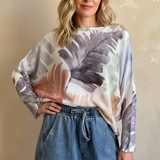 Front portrait of model wearing the Livia Made in Italy batwing printed sweater in watercolor palm multi print