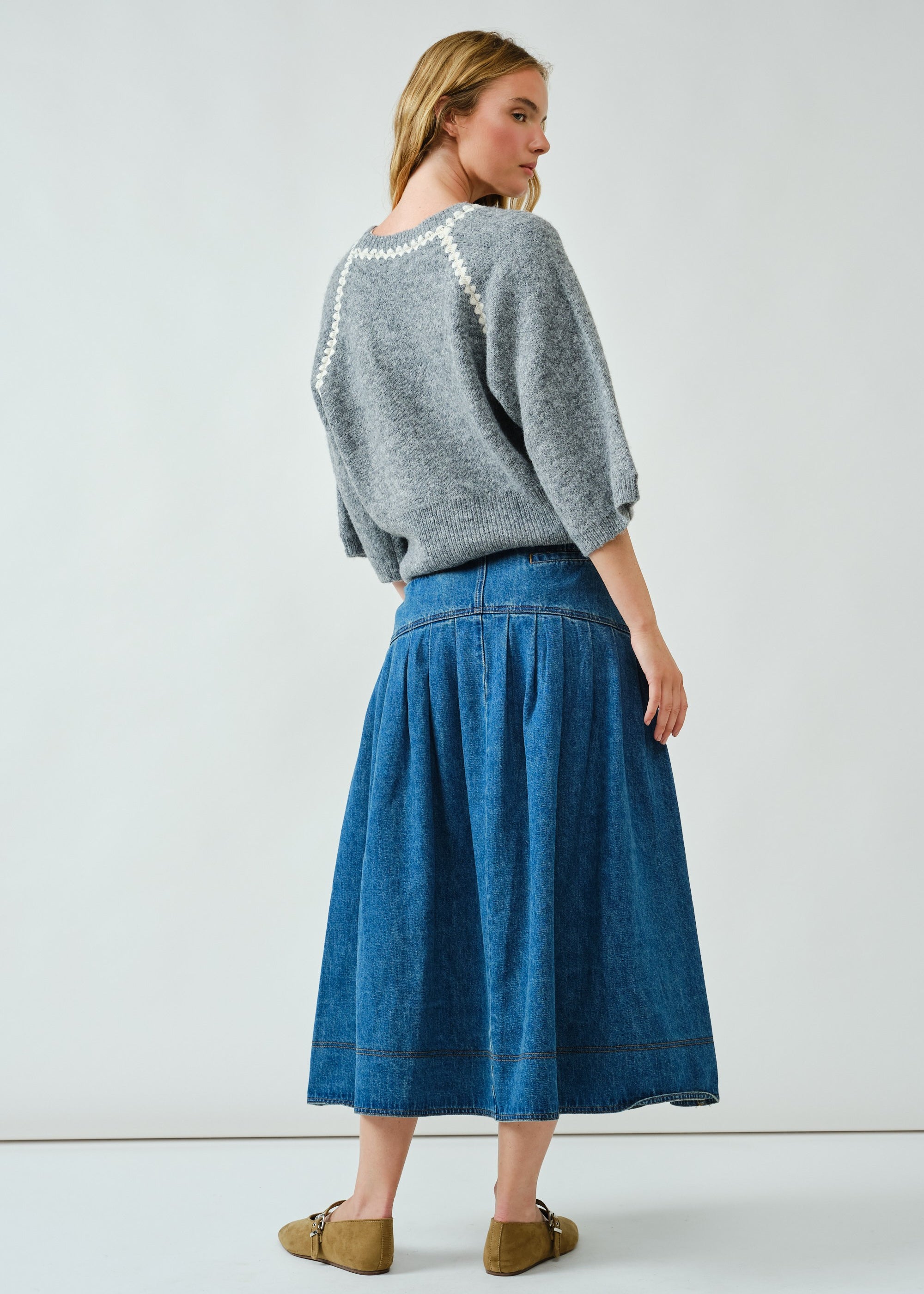 Back view of the denim midi skirt showing basque waist detail