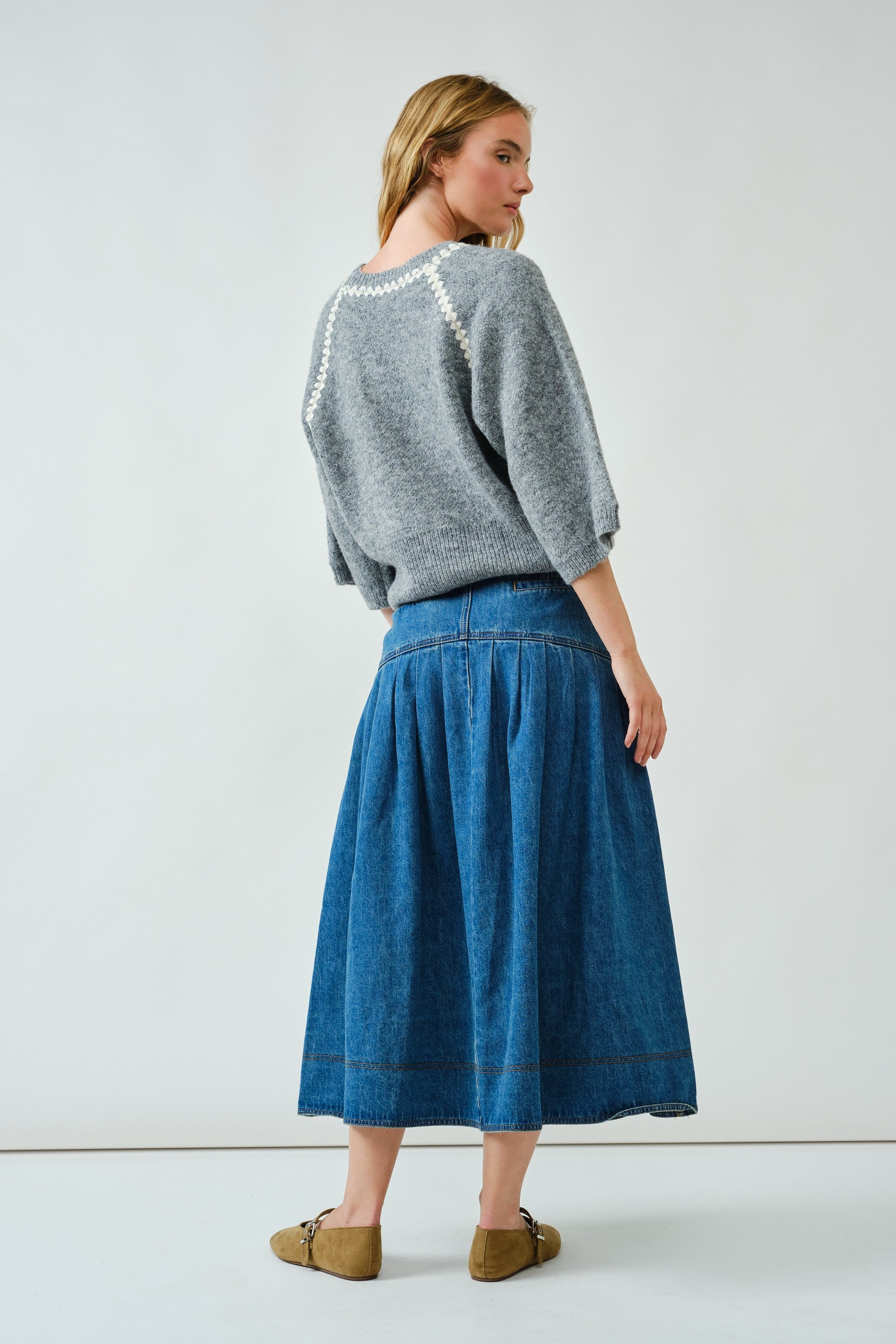 Back view of the denim midi skirt showing basque waist detail