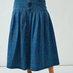Front portrait of the Lotus Basque Denim Midi Skirt showing basque waist and structured fit