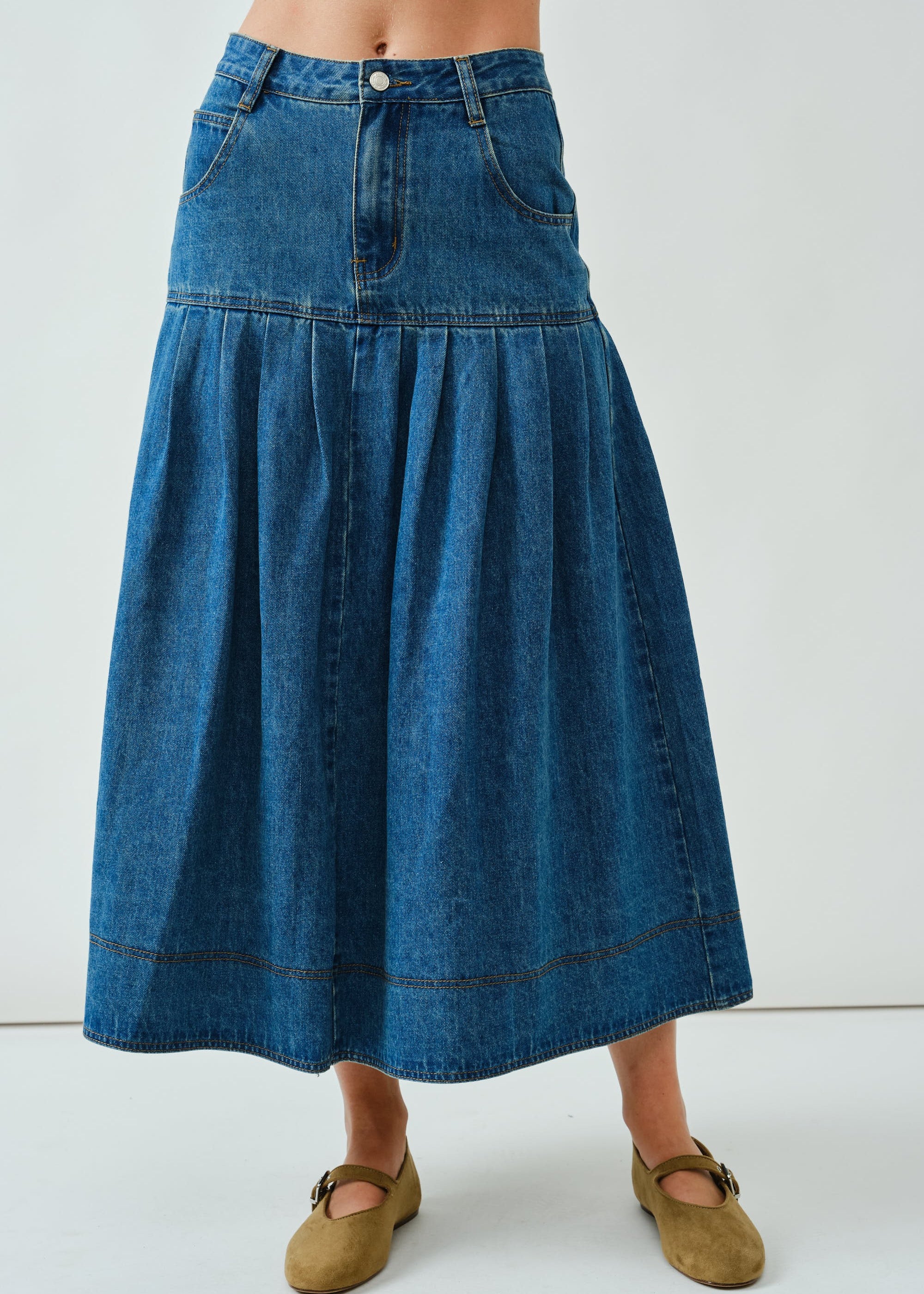 Front portrait of the Lotus Basque Denim Midi Skirt showing basque waist and structured fit