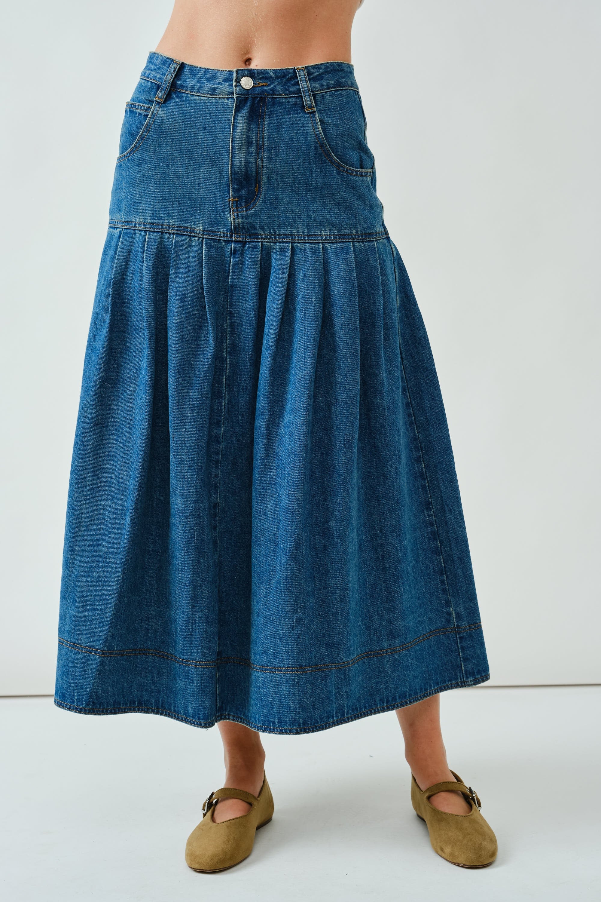 Front portrait of the Lotus Basque Denim Midi Skirt showing basque waist and structured fit