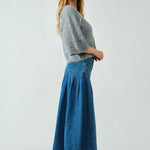 Side view of the Lotus Basque Denim Midi Skirt highlighting flared silhouette