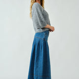 Side view of the Lotus Basque Denim Midi Skirt highlighting flared silhouette