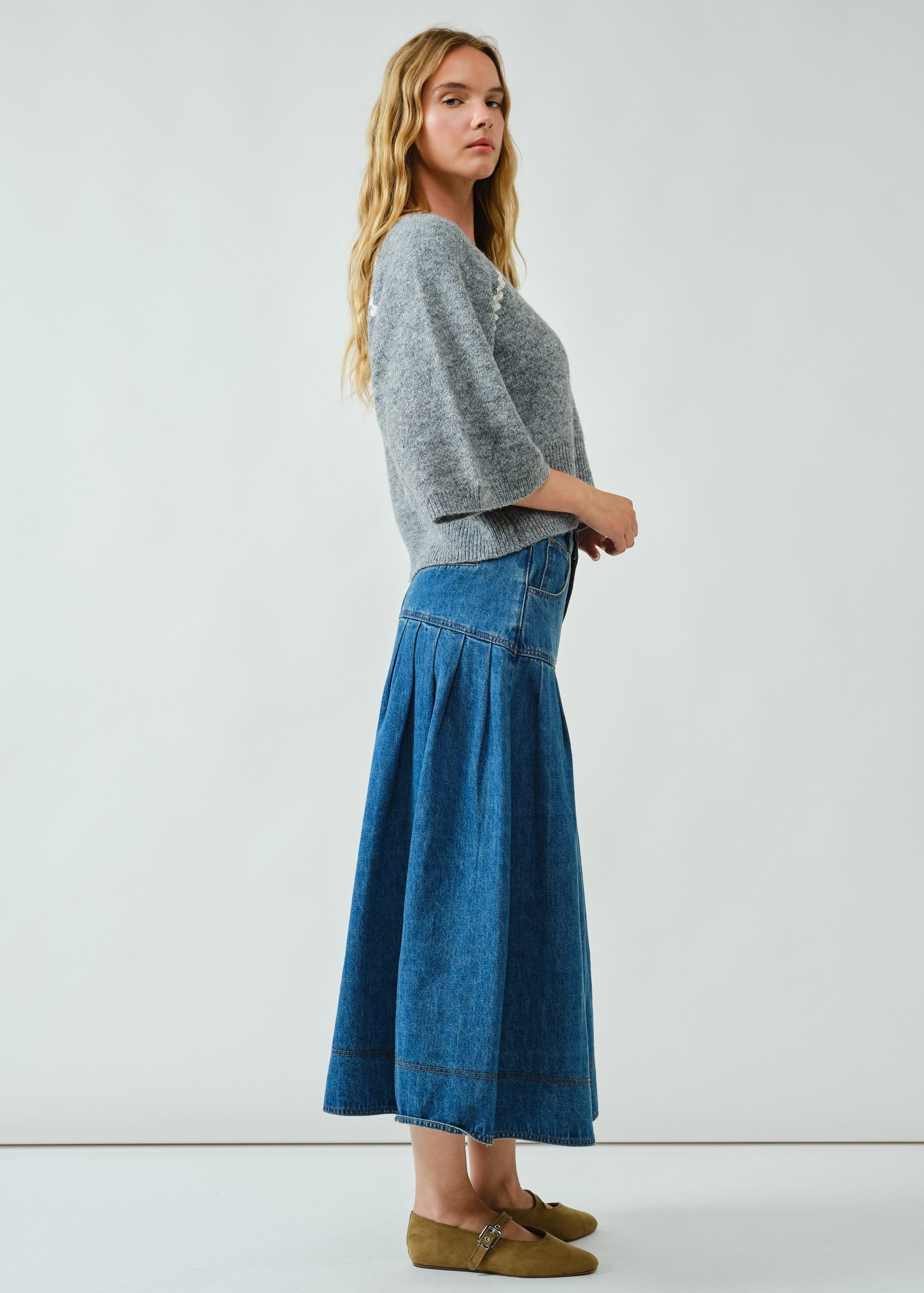 Side view of the Lotus Basque Denim Midi Skirt highlighting flared silhouette