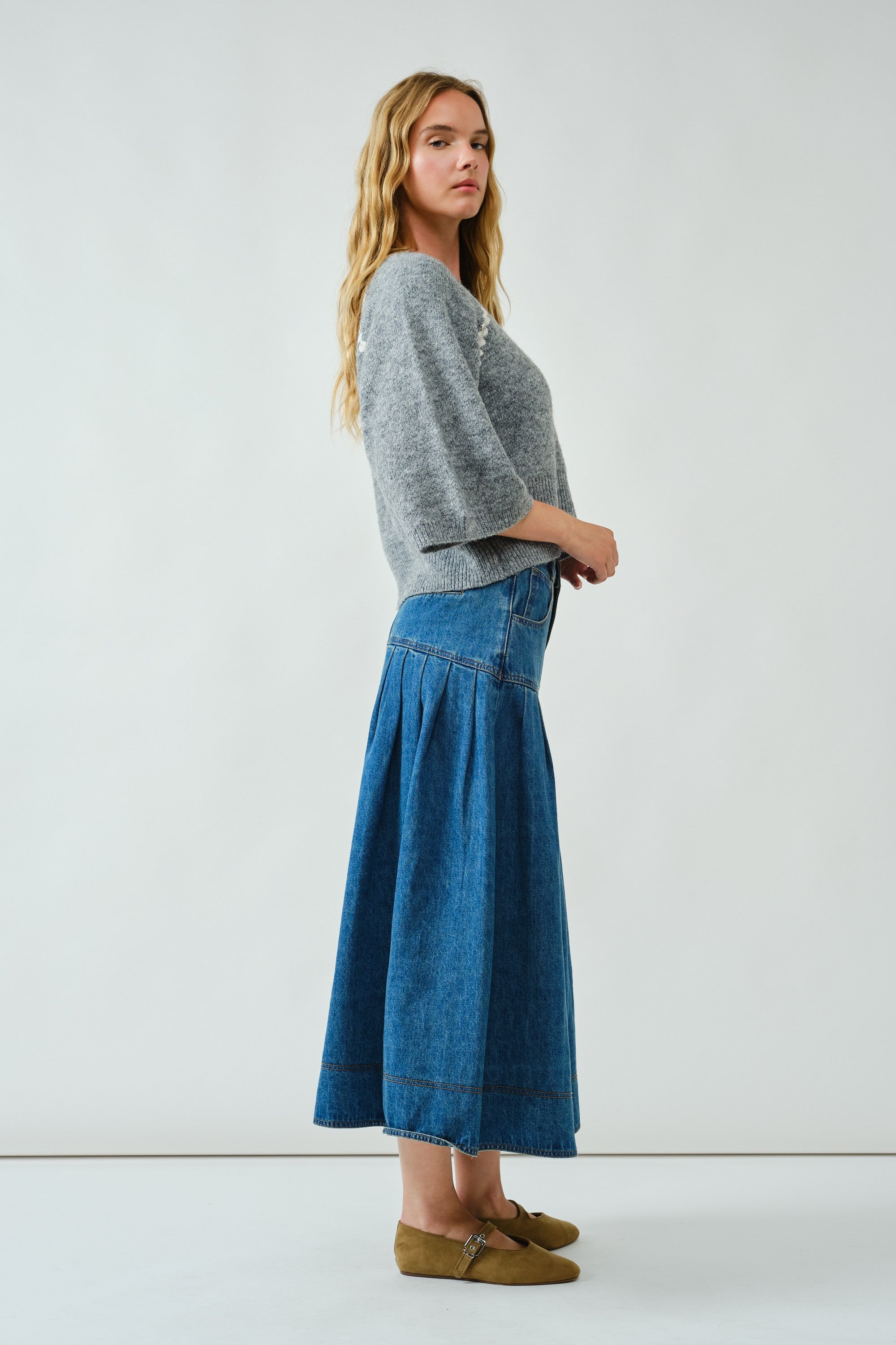 Side view of the Lotus Basque Denim Midi Skirt highlighting flared silhouette