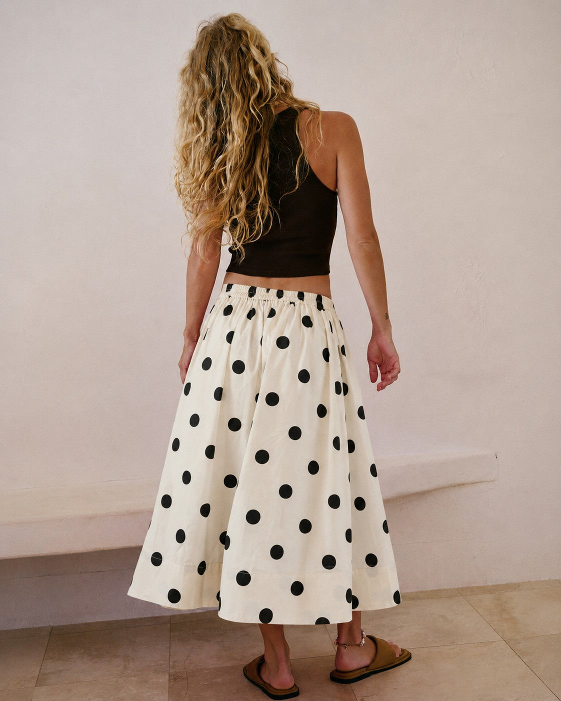 Lowen Full Midi Skirt in Polka Dot Cream,back view of full A-line midi skirt with black polka dots and gathered waist