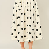 Lowen Full Midi Skirt in Polka Dot Cream, front view of full A-line midi skirt with black polka dots and gathered waist