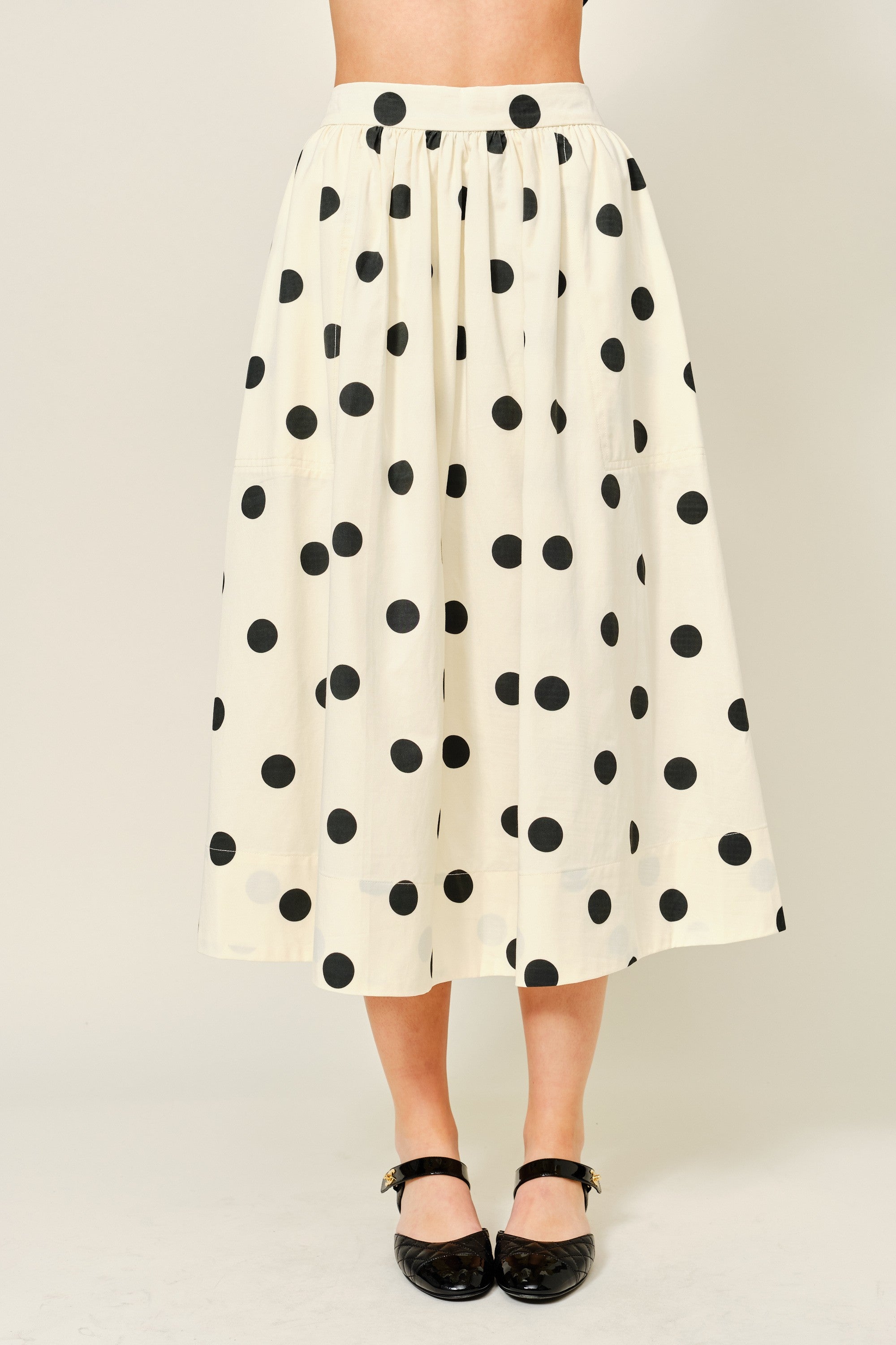 Lowen Full Midi Skirt in Polka Dot Cream, front view of full A-line midi skirt with black polka dots and gathered waist