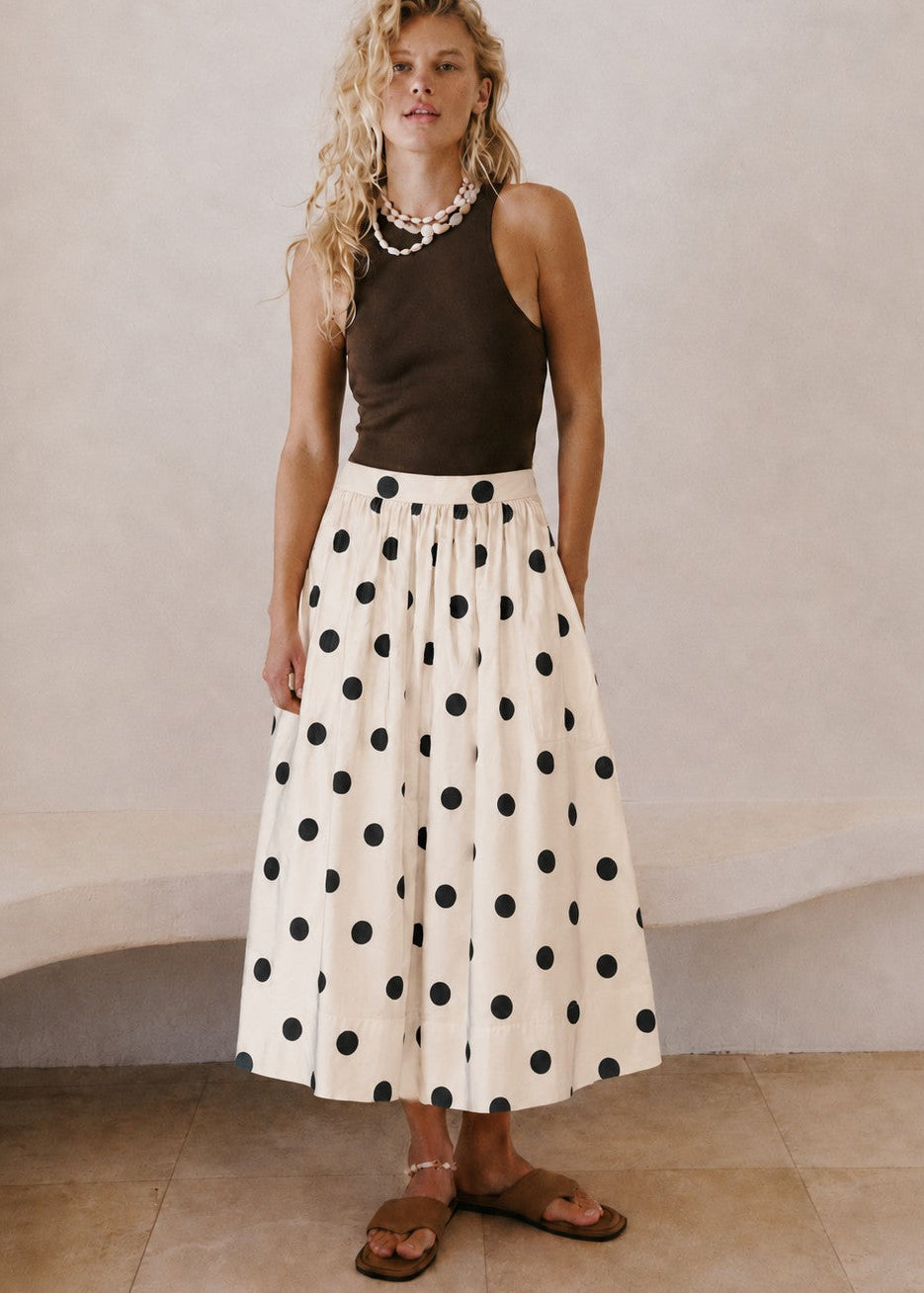 Lowen Full Midi Skirt in Polka Dot Cream styled with a dark sleeveless top and sandals for an effortless everyday outfit