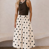Lowen Full Midi Skirt in Polka Dot Cream styled with a dark sleeveless top and sandals for an effortless everyday outfit