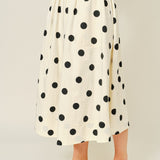 Side view of Lowen Full Midi Skirt in Polka Dot Cream showing the full midi length, soft volume, and side pocket detail