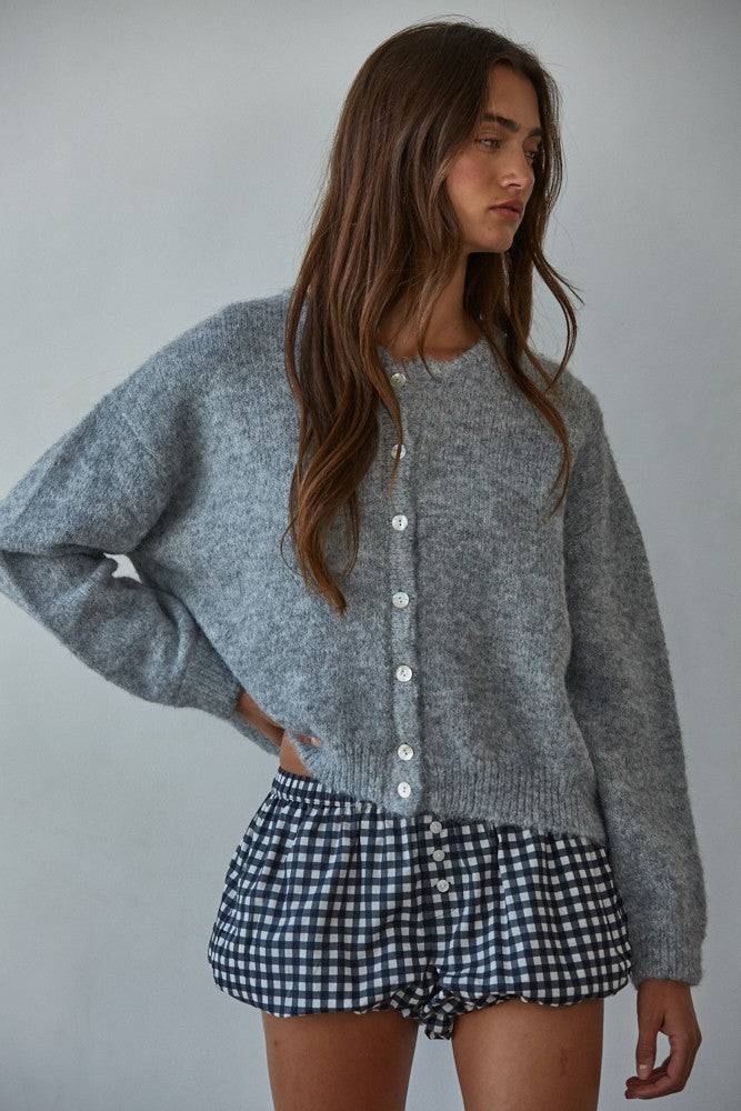 Woman wearing  Lucas Button-Down Knit Cardigan in heather grey with round neckline and buttons