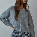 Woman wearing  Lucas Button-Down Knit Cardigan in heather grey with round neckline and buttons