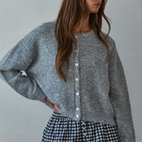 Woman wearing  Lucas Button-Down Knit Cardigan in heather grey with round neckline and buttons