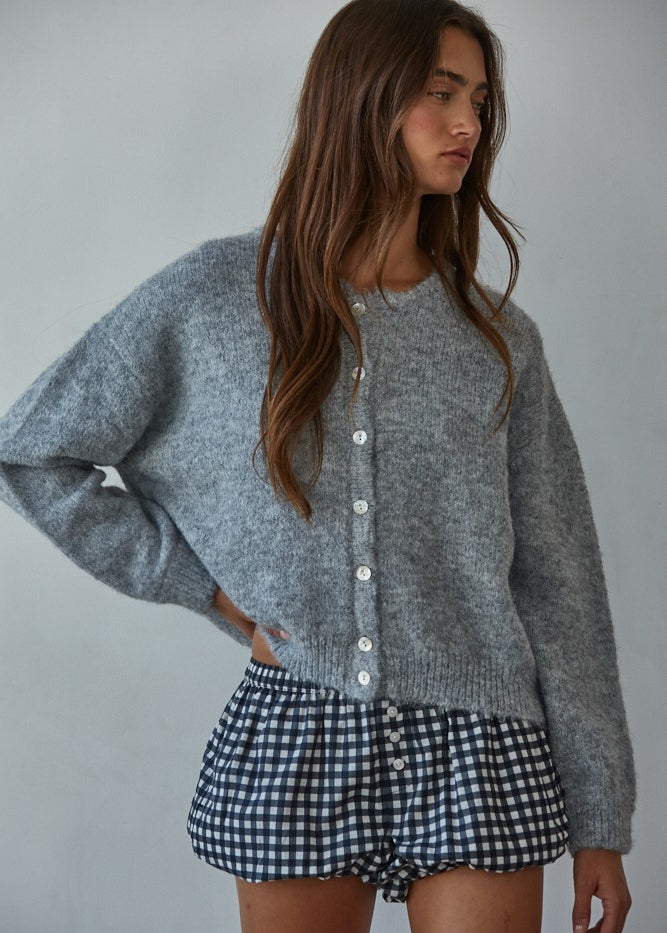 Woman wearing  Lucas Button-Down Knit Cardigan in heather grey with round neckline and buttons