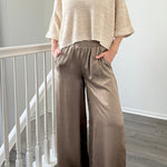 Person wearing Luna Satin Wide Leg Pants in Olive 