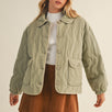 Front portrait of model wearing the Magnolia Wave Quilted Cotton Jacket in olive