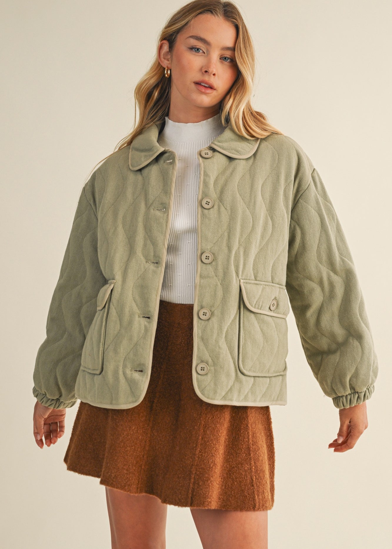 Front portrait of model wearing the Magnolia Wave Quilted Cotton Jacket in olive